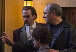 Buscarini (right) directs Fiennes and Mazouz.